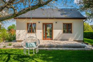 a swing in front of a small house at Lime weekendhouse 1-2 in Balatonakarattya +25 photos