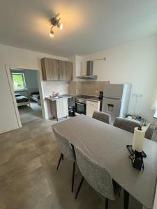a kitchen with a table and chairs in a room at Home15 Kassel in Kassel +3 photos