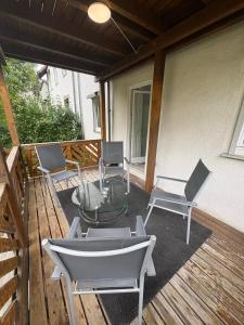 a patio with chairs and a glass table on a deck at Home15 Kassel in Kassel