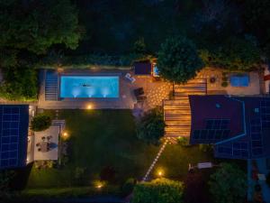 an overhead view of a swimming pool in a yard at night at Lime weekendhouse 1-2 in Balatonakarattya