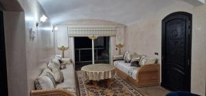 a living room with a couch and a table at Tiguert serenity in Tiguert +10 photos
