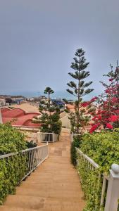 a walkway with trees and flowers on a building at Tiguert serenity in Tiguert