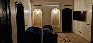 a living room with two chairs and a television at Tiguert serenity in Tiguert
