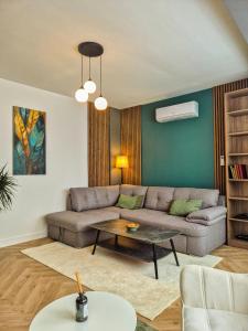a living room with a couch and a table at Boutique Apartment Suceava Modern Parcare WiFi Rapid in Ipoteşti