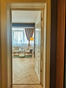 an open door to a room with a living room at Boutique Apartment Suceava Modern Parcare WiFi Rapid in Ipoteşti