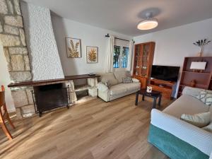 a living room with a couch and a fireplace at El Hidalgo Costa del Sol in Torre de Benagalbón