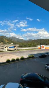 a view of a parking lot with a car on the road at Mahle Hotel - BR 116, km 48 in Campina Grande do Sul