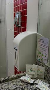 a toaster sitting on a counter in a bathroom at Mahle Hotel - BR 116, km 48 in Campina Grande do Sul