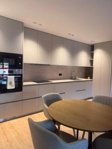 a kitchen with a wooden table and chairs and a table at Apartamento Cimo da Barca in Ponte da Barca