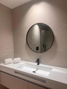 a bathroom with a sink and a mirror at Apartamento Cimo da Barca in Ponte da Barca +12 photos