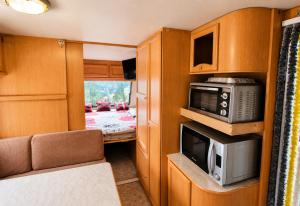 an rv kitchen with a microwave and a microwave at Camping Principata in Brungaj