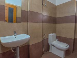 a bathroom with a sink and a toilet at Sky Dale Pool Resort Munnar in Munnar +52 photos