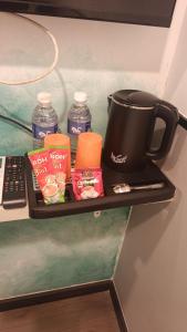 a shelf with a coffee pot and other items on it at THE SWAN loft in Sibu