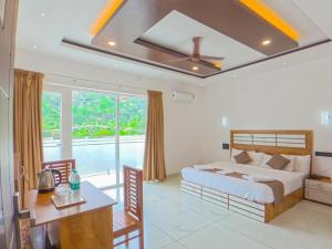 a bedroom with a bed and a table and a desk at Sky Dale Pool Resort Munnar in Munnar