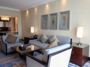 a living room with a couch and a table at Swissotel Jeddah Al Hamra in Jeddah