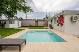 a swimming pool in the backyard of a house at The Mango House in Fajardo