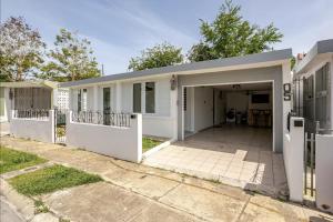 a house with a garage and a driveway at The Mango House in Fajardo