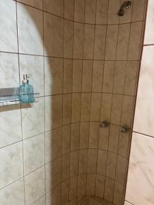 a shower with a tile wall with a faucet at Casa Junto al Rio in Arequipa