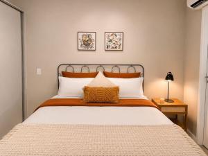 a bedroom with a large bed with white pillows at Praça Madá - Anystay in São Paulo +82 photos