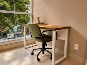 a desk with a chair in front of a window at Praça Madá - Anystay in São Paulo