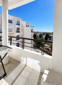 a balcony with a view of a building at Chic & Comfortable Stay in Monastir