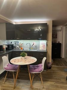 a kitchen with a table and chairs in a kitchen at Cozy Rhodes Studio in Rhodes Town