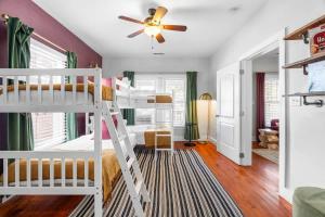 a bedroom with a bunk bed and a ceiling fan at Backyard Hangout Firepit Giant Connect 4 & BBQ in Raleigh