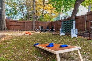 a ping pong table in a yard with a playground at Backyard Hangout Firepit Giant Connect 4 & BBQ in Raleigh