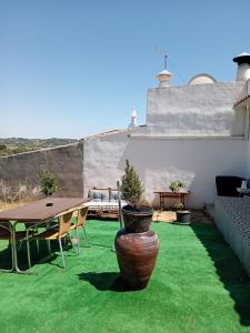 a patio with a table and a potted plant at Campo Dias in Silves