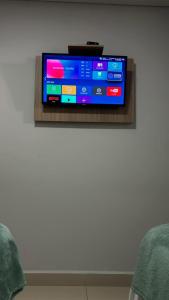 a flat screen tv on a wall at Mahle Hotel - BR 116, km 48 in Campina Grande do Sul +18 photos
