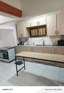 a kitchen with a wooden table in the middle at sea flower in Lomé