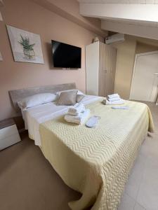 a bedroom with a large bed with towels on it at Luxury Apartment Da Giovanni in Caserta