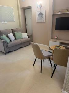 a living room with a couch and a table and chairs at Luxury Apartment Da Giovanni in Caserta