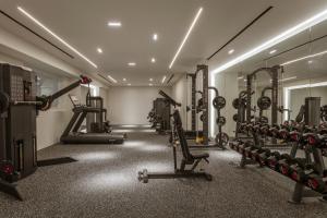 a gym with lots of tread machines and treadles at Aqua Luxury Suites by NOMÉE Hospitality Group in Imerovigli