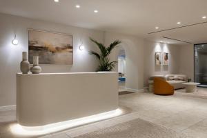 a lobby with a reception desk and a living room at Aqua Luxury Suites by NOMÉE Hospitality Group in Imerovigli +57 photos