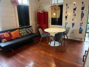 a living room with a couch and a table at Coffee Mama Stay in Paramaribo