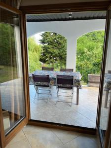 a patio with a table and two chairs on a patio at Eko Haus Tesla in Srnava +33 photos
