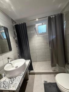 a bathroom with a sink and a shower at Dimi's Apartment Avdira in Ávdhira