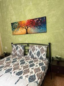 a bedroom with a bed with a painting on the wall at Dimi's Apartment Avdira in Ávdhira