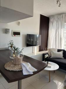 a living room with a couch and a table at M&M Nest in Windhoek