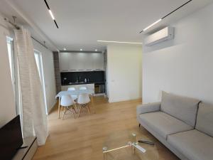 a living room with a couch and a table at DfA in Tirana