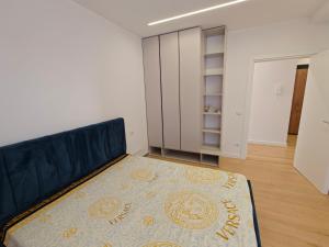 a bedroom with a bed and a rug on the floor at DfA in Tirana