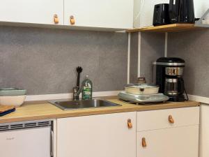 a kitchen counter with a sink and a coffee maker at Hygge Cabin in Rostock