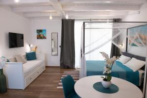 a living room with a couch and a table at Centro Storico Rooms & Suites in Manfredonia