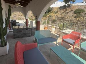a group of chairs and a table on a patio at El Nido in Mojácar