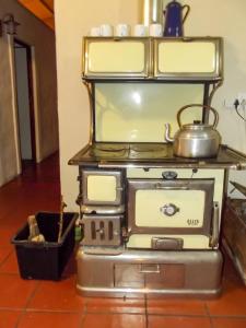 a stove with a pot on top of it at Barnfires Farmhouse in Denysville +22 photos