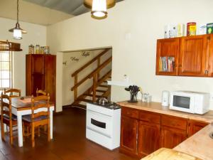 a kitchen with a table and a stove and a microwave at Barnfires Farmhouse in Denysville