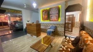 a living room with a couch and a table at Tripathi's Rampath Inn Ayodhya in Ayodhya