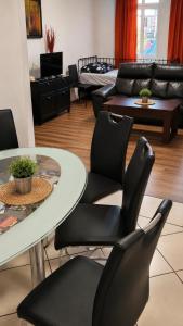 a living room with a table and chairs at 110m2 Old Town Apartment on Danube Promenade 3BR 2BA Up to 9 Guests in Bratislava