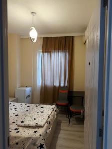 a hotel room with two beds and a window at Hotel Palm Gonio in Kvariati